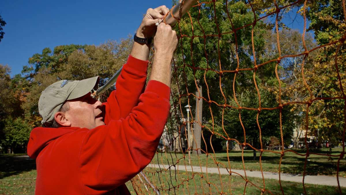 Soccer Sisters United Head Coach Walter Stewart pieces together a makeshift replacement goal. (Photo by Bas Slabbers)